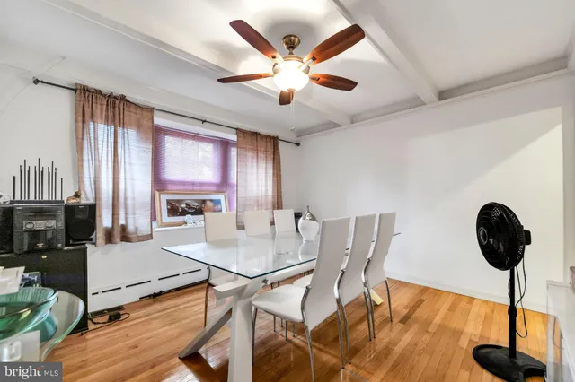 a view of a dining room with furniture and a large window