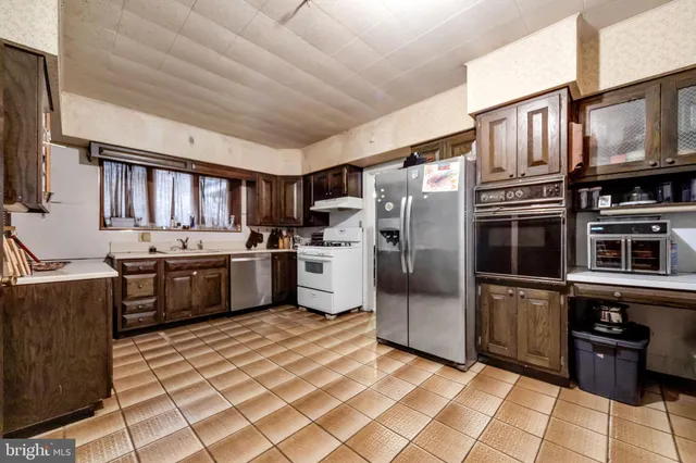 a kitchen with stainless steel appliances and a refrigerator