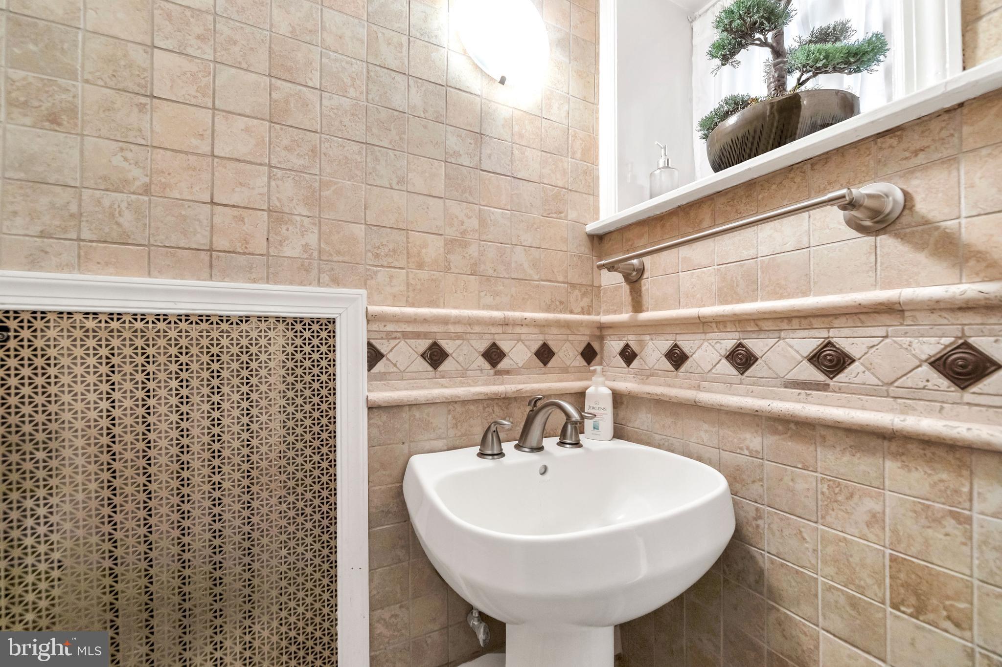 817 Ashbourne Road Cheltenham, PA 19012 - Photo 18 of 38 a bathroom with a sink a vanity and a shower