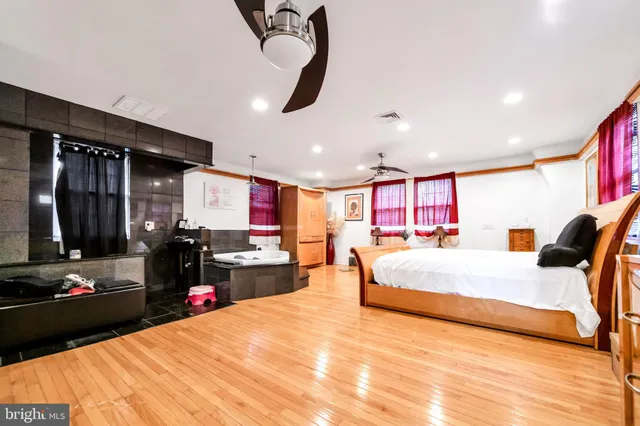 a bed room with a bed mirror and furniture