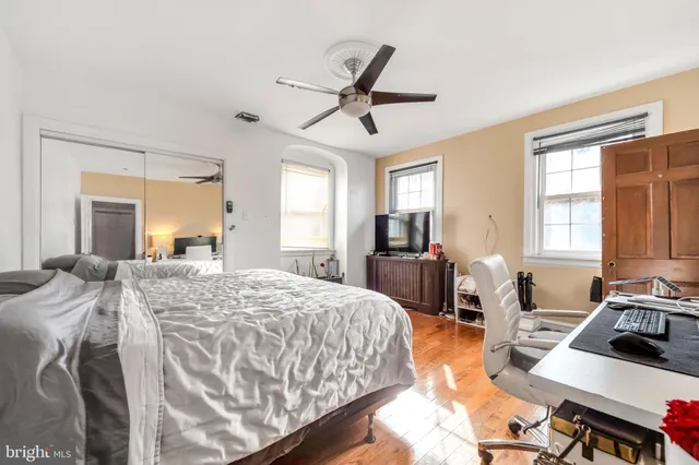 a bedroom with a bed window and dresser