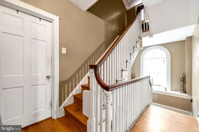 a view of staircase with wooden floor and a window