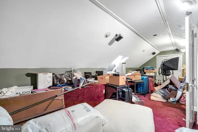 a living room with furniture kitchen view and a chandelier