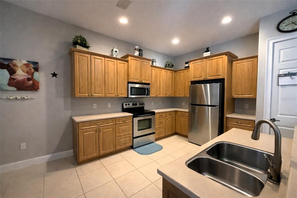 10127 Tria Drive Weeki Wachee, FL 34613 - Photo 14 of 33 a kitchen with stainless steel appliances granite countertop a refrigerator sink and stove