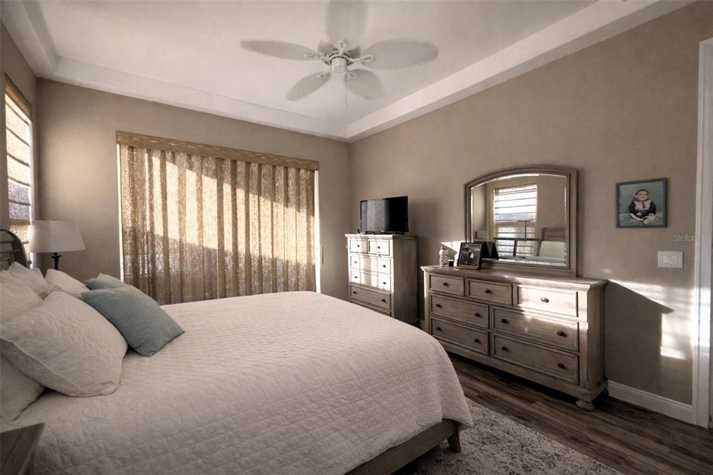 10127 Tria Drive Weeki Wachee, FL 34613 - Photo 16 of 33 a bedroom with a large bed and a dresser