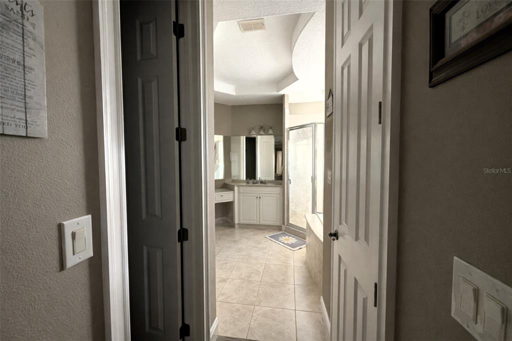 10127 Tria Drive Weeki Wachee, FL 34613 - Photo 17 of 33 a view of a hallway with a livingroom and a bathroom