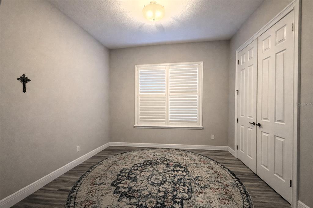 10127 Tria Drive Weeki Wachee, FL 34613 - Photo 19 of 33 a big room with wooden floor and a window