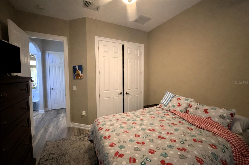 10127 Tria Drive Weeki Wachee, FL 34613 - Photo 22 of 33 a bedroom with a bed and a tv