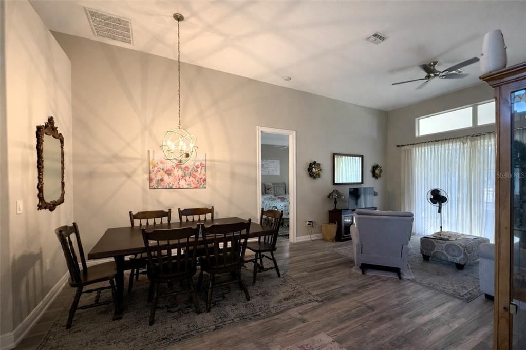 10127 Tria Drive Weeki Wachee, FL 34613 - Photo 8 of 33 a view of a dining room with furniture and chandelier