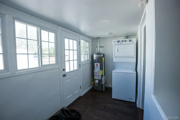 a view of a storage & utility room with closet wooden floor