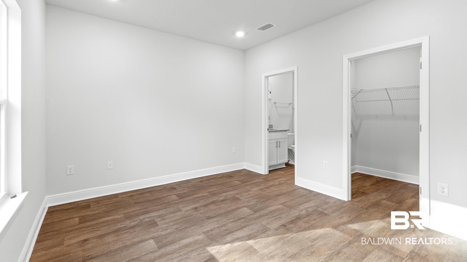 13356 Shea Circle Foley, AL 36535 - Photo 6 of 15 Spacious room featuring wood-finish flooring, recessed lighting, and a window for natural illumination