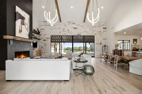 a living room with furniture and a floor to ceiling window