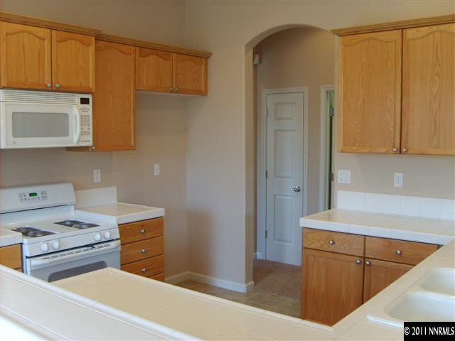 2440 Baton Drive Reno, NV 89521 - Photo 3 of 13 a kitchen with appliances cabinets and a sink