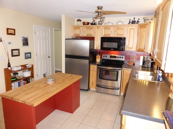 202 Cutler Road Warren, MA 01083 - Photo 8 of 30 a kitchen with stainless steel appliances kitchen island granite countertop a refrigerator and a stove top oven