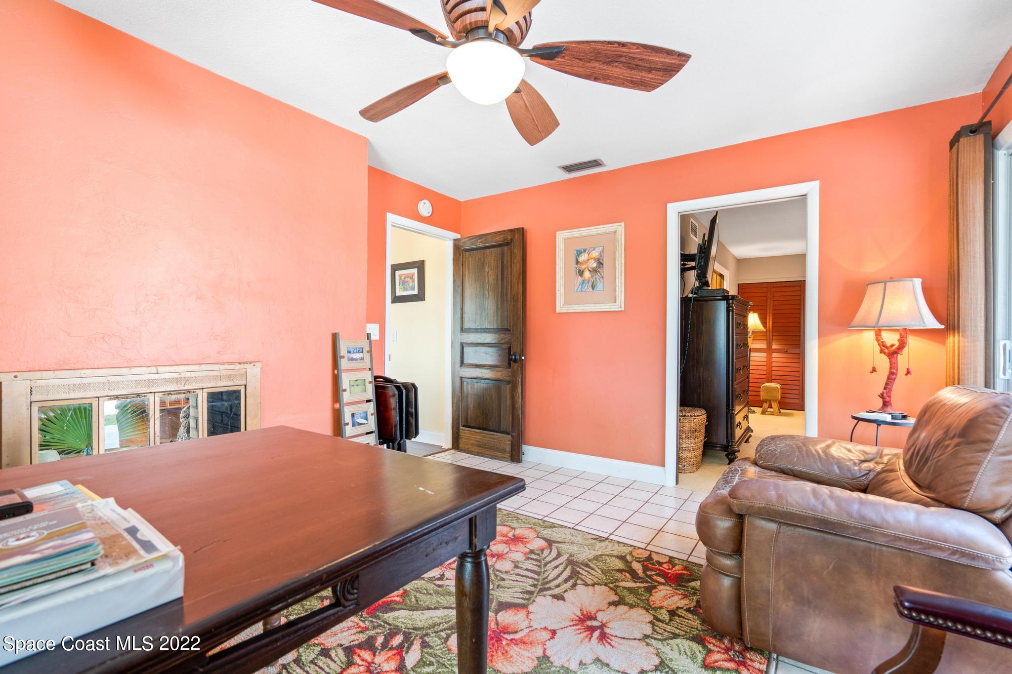 14 Country Club Road Cocoa Beach, FL 32931 - Photo 21 of 64 a bed room with a bed and a chandelier