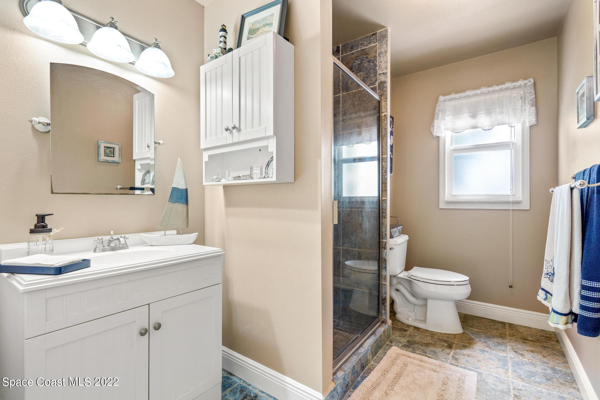 14 Country Club Road Cocoa Beach, FL 32931 - Photo 32 of 64 a bathroom with a sink toilet and shower