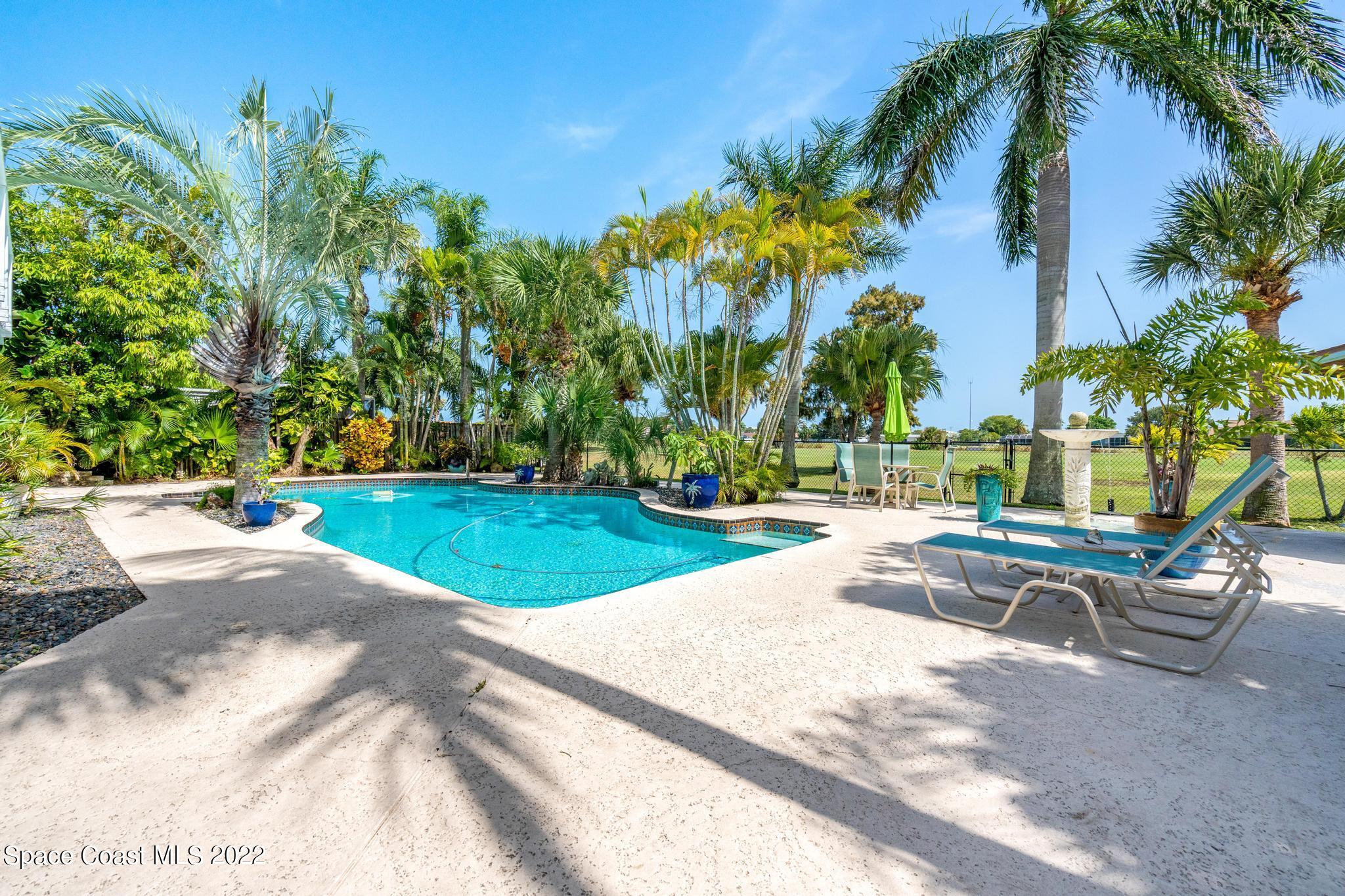 14 Country Club Road Cocoa Beach, FL 32931 - Photo 46 of 64 a view of backyard with swimming pool and seating space