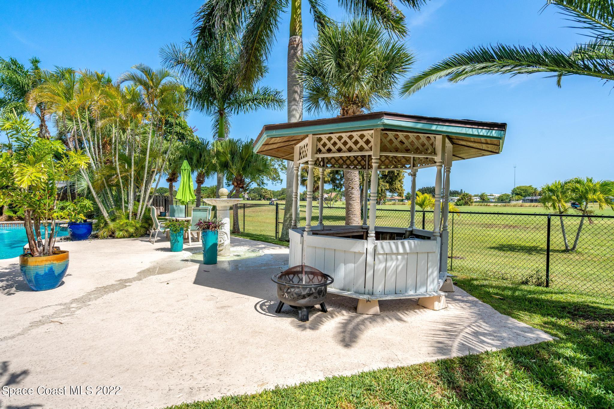 14 Country Club Road Cocoa Beach, FL 32931 - Photo 51 of 64 a view of outdoor space with swimming pool and seating