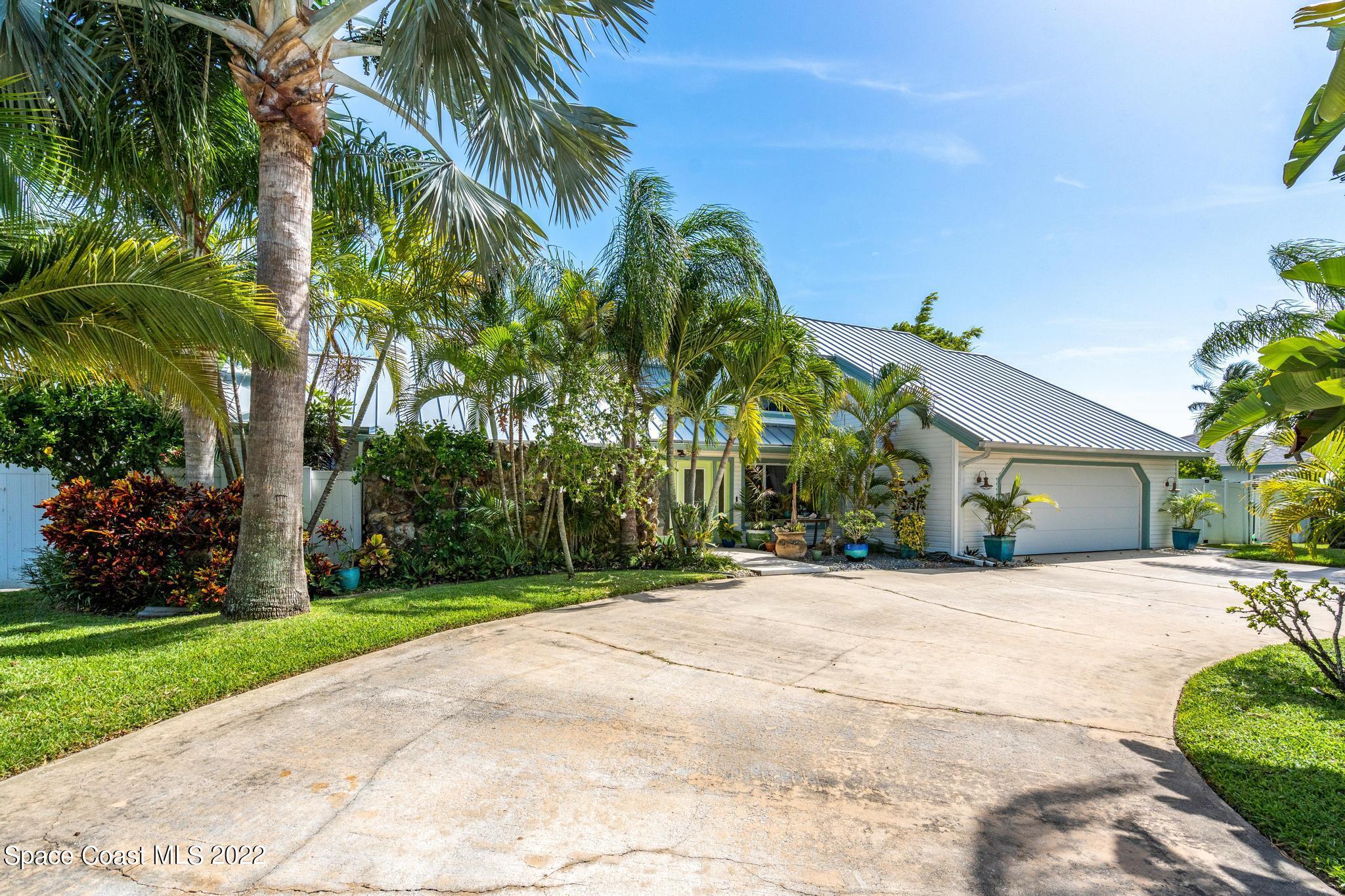 14 Country Club Road Cocoa Beach, FL 32931 - Photo 57 of 64 a front view of house with a garden