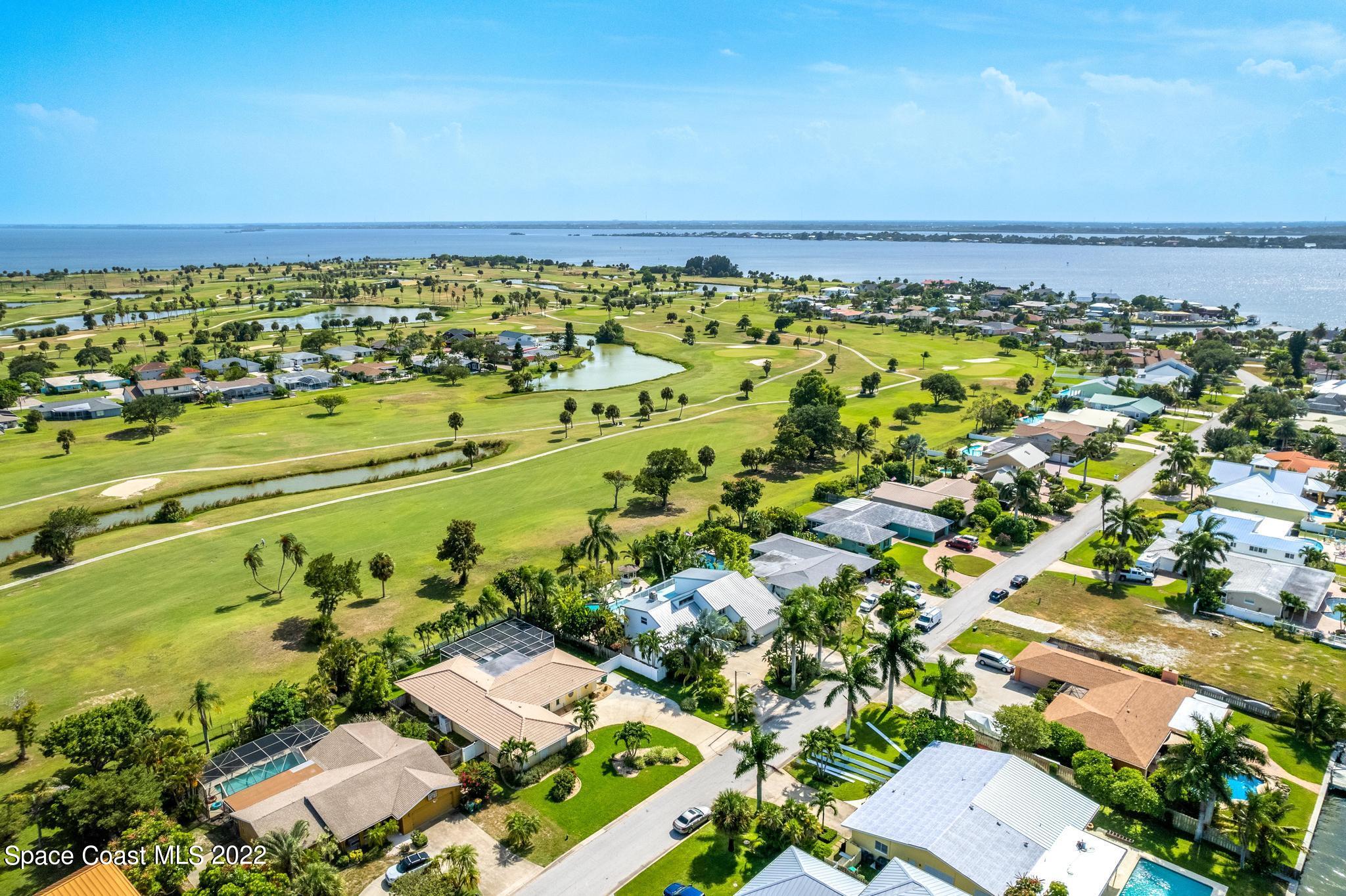 14 Country Club Road Cocoa Beach, FL 32931 - Photo 62 of 64 an aerial view of residential building and lake