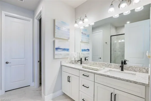 a bathroom with a glass shower door