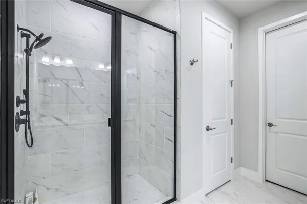 a bedroom with two beds and a chandelier