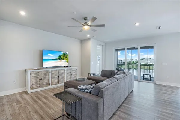 a living room with furniture and a wooden floor