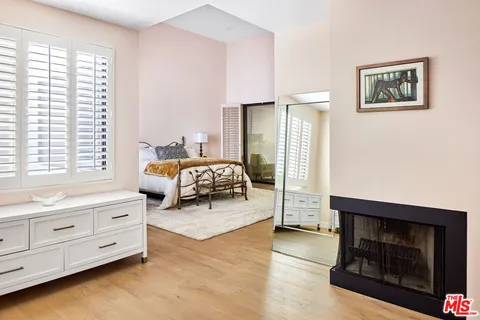 a bedroom with furniture and a fireplace