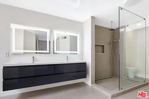 a bathroom with a double vanity sink and a bathtub