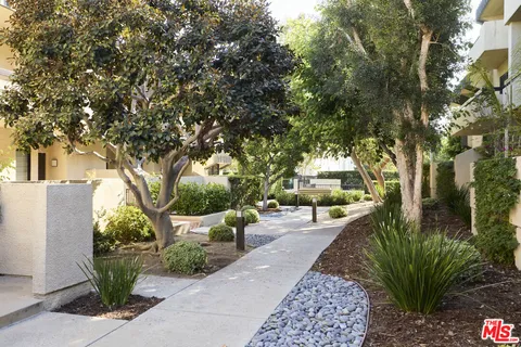a view of yard with swimming pool and green space