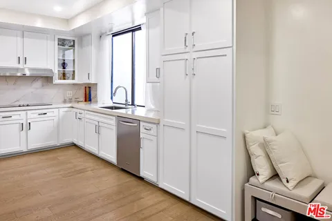 a kitchen with white cabinets and white appliances