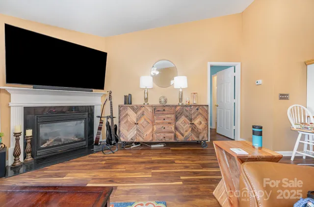 a living room with furniture fireplace and flat screen tv