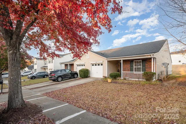 a view of a house with a large tree in front of it