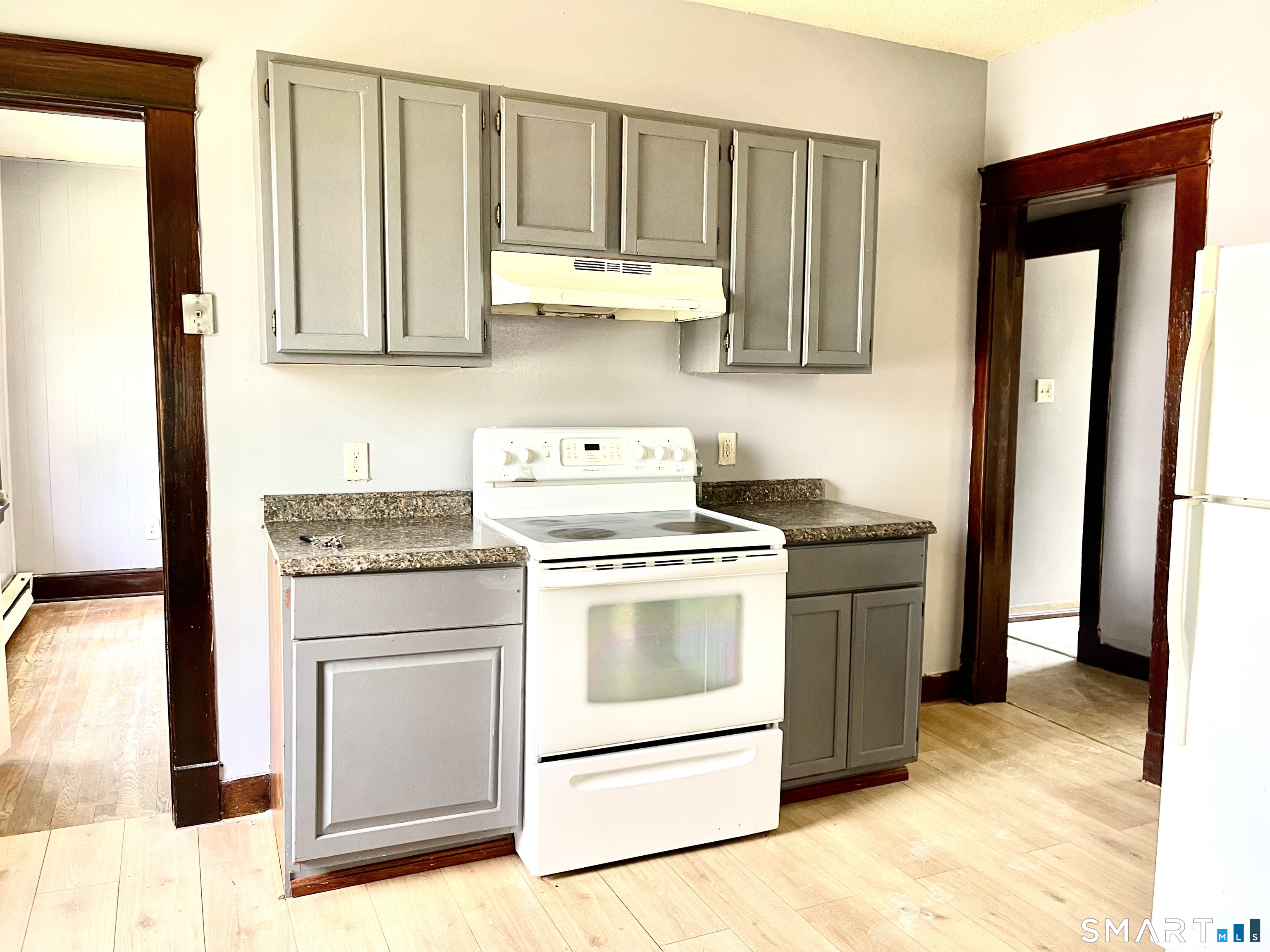 146 Charles Street, Unit 3 Waterbury, CT 06708 - Photo 4 of 20 a kitchen with stainless steel appliances granite countertop a stove a sink and a refrigerator