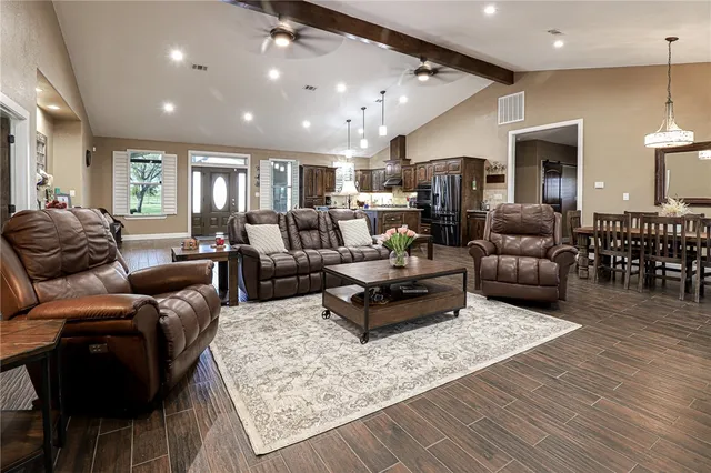 a living room with furniture and wooden floor