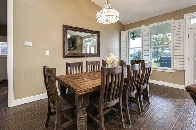 a view of a dining room with furniture wooden floor and chandelier