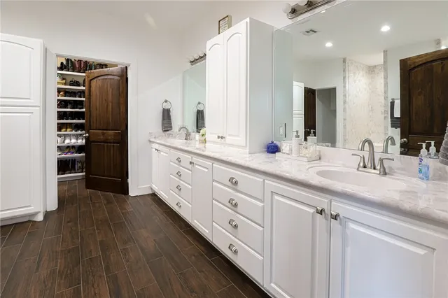 a bathroom with a double vanity sink and a mirror