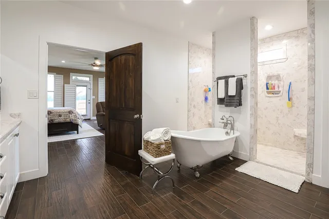 a living room with furniture a wooden floor and a view of bathroom