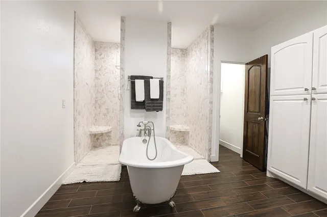 a bathroom with a bathtub and shower