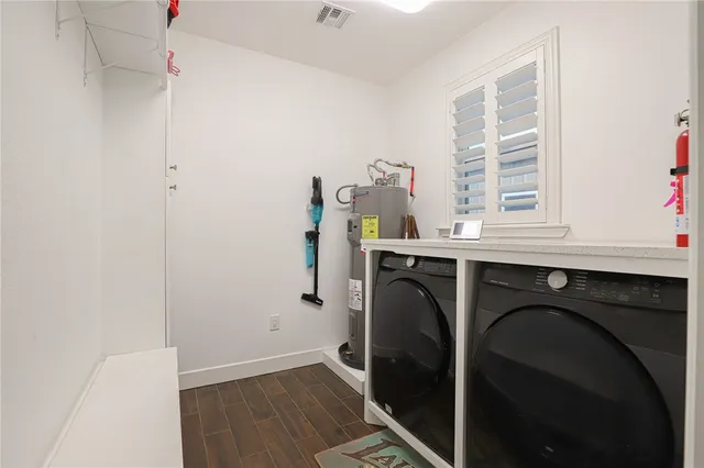 a utility room with closet dryer and washer
