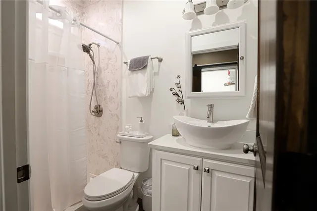 a bathroom with a toilet sink and shower