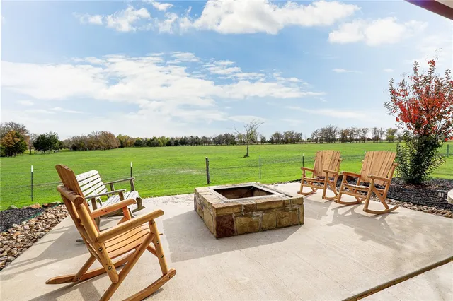 an outdoor sitting area with couch and wooden fence