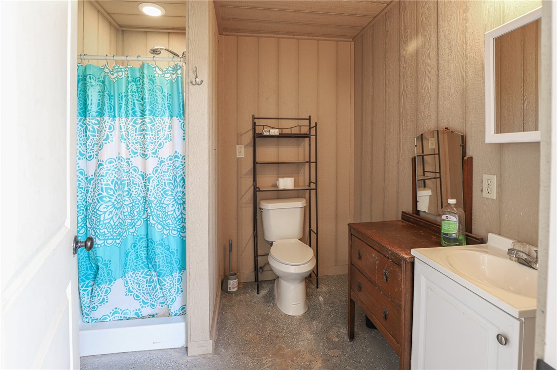 291 Lcr 644 Thornton, TX 76687 - Photo 35 of 51 a bathroom with a granite countertop toilet a sink and a shower