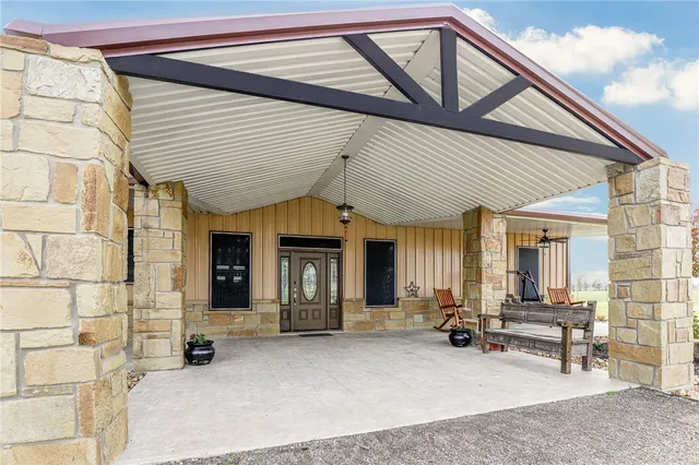 a view of a patio with table and chairs