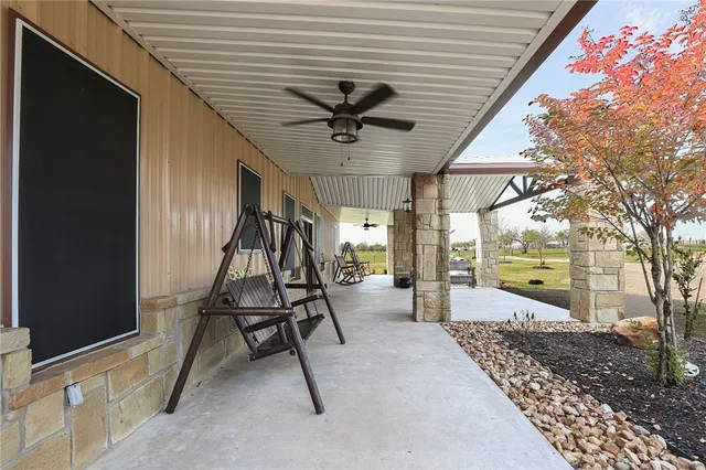 a view of a porch with a table and chairs