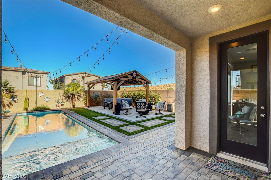 9688 Rankin Rdg Court Las Vegas, NV 89178 - Photo 51 of 53 An inviting backyard oasis offers a sparkling pool and a cozy covered patio for outdoor entertaining.
