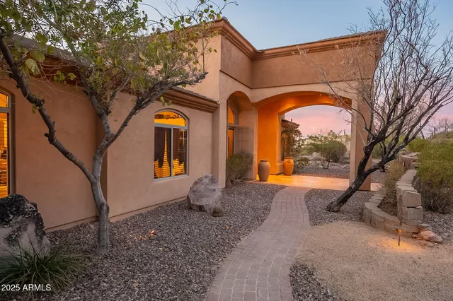 a view of a dining room with furniture and a chandelier
