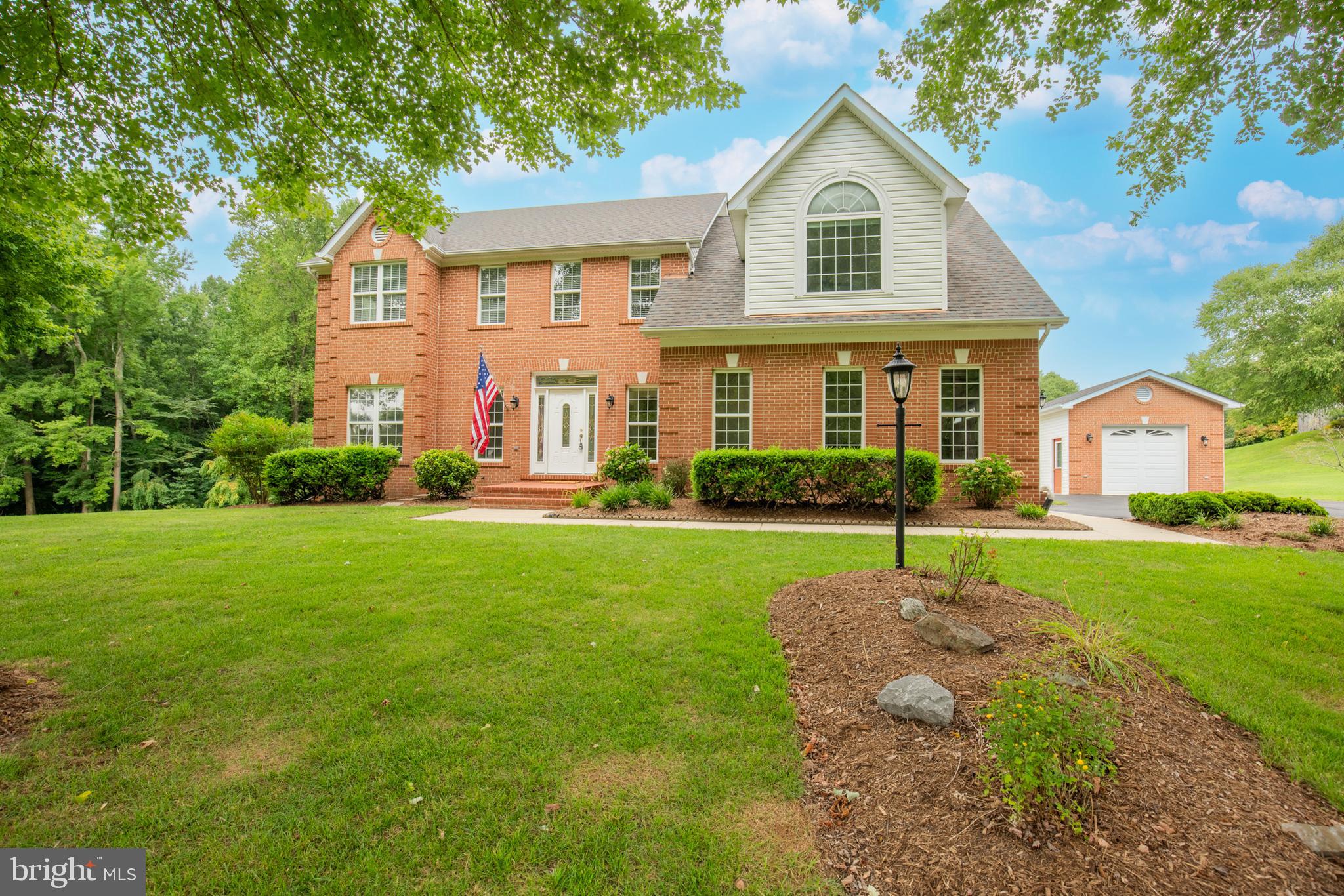 539 Small Reward Road Huntingtown, MD 20639 - Photo 2 of 34 a front view of house with yard and green space