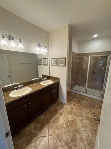 a spacious bathroom with a sink and a mirror