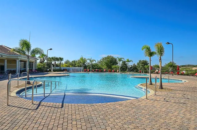 a view of a swimming pool with a lounge chair